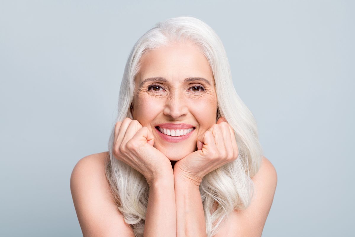 woman with grey hair smiling at camera